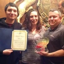 Hearts with Hope members holding an award and certificate