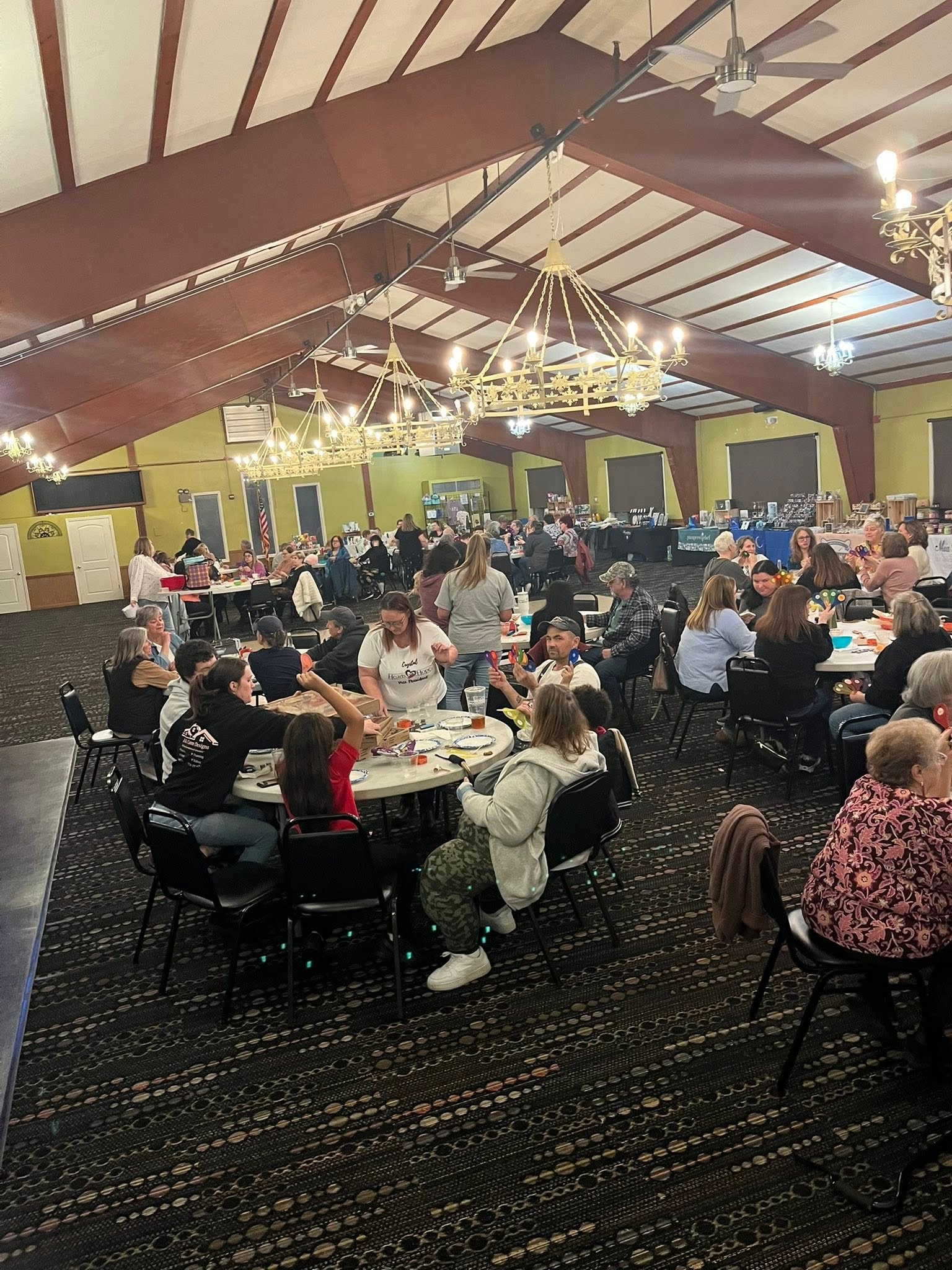 Hearts with Hope community event with attendees gathered at tables in a large venue