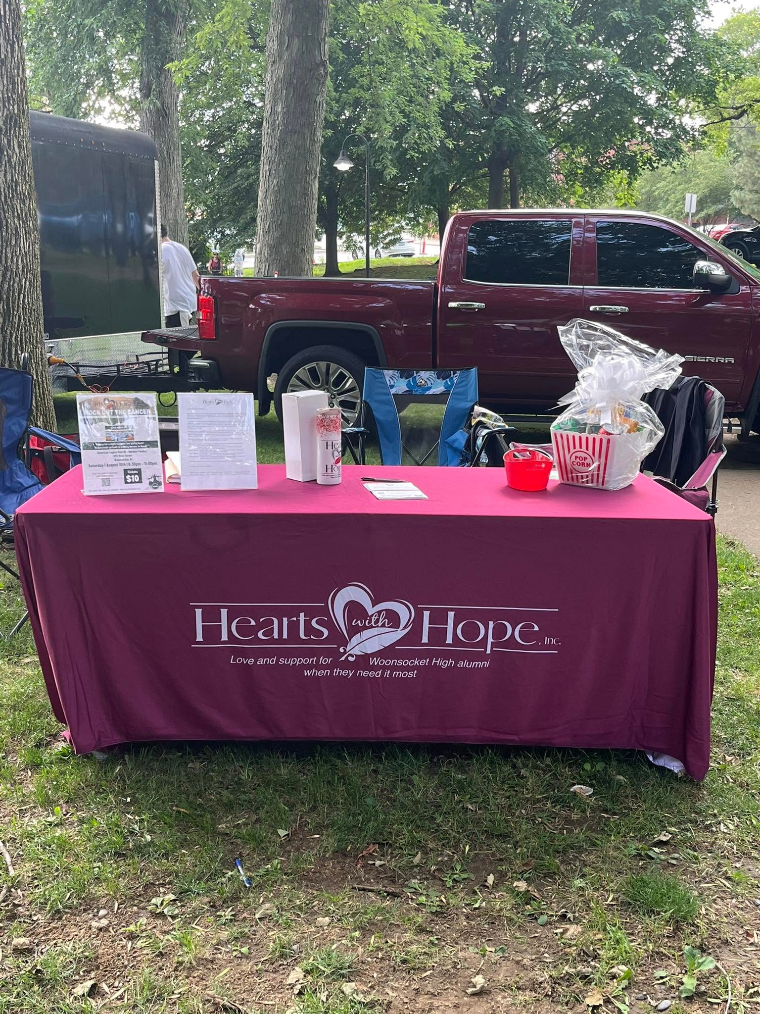 Hearts with Hope branded table at an outdoor community event