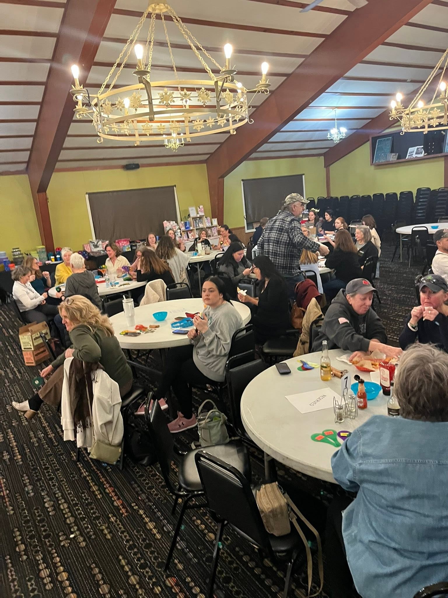 Guests seated at tables participating in a Hearts with Hope Quarter Auction